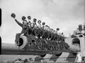 Sailors of the South African Royal Naval Volunteer Reserve sitting on one of the 16-inch gun barrels of HMS Nelson during World War II.
