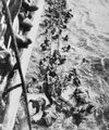 HMS Dorsetshire picking up survivors following the sinking of Bismarck, 27 May 1941.