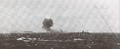 HMS Rodney firing on Bismarck, which can be seen burning in the distance, 27 May 1941.