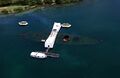 Aerial view of the USS Arizona Memorial, showing the wreck and oil seepage from the ship's bunkers.