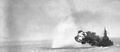Massachusetts shelling Kamaishi, Honshū, Japan on 14 July 1945. Outbound projectiles of a full broadside of her 16" guns are visible in upper left of photo.